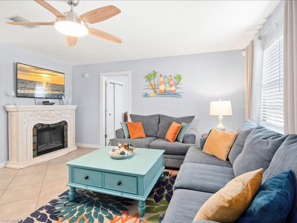 2469 Florida Avenue Naples, FL 34112 - Photo 8 of 31 Tiled living room featuring a high end fireplace and ceiling fan