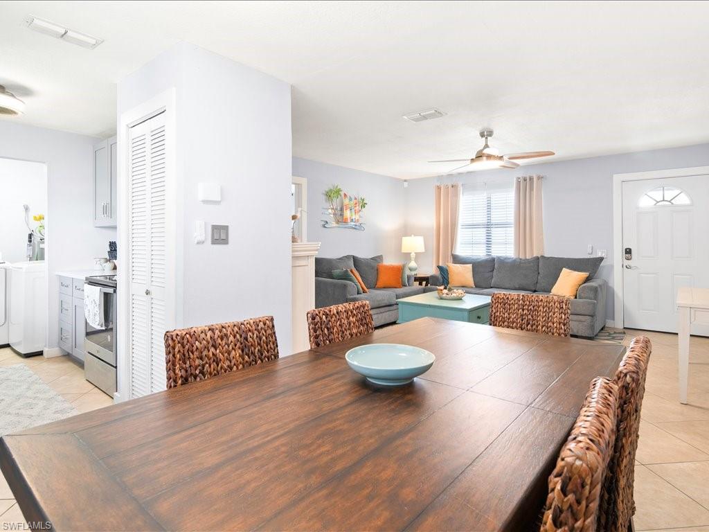 2469 Florida Avenue Naples, FL 34112 - Photo 9 of 31 Dining room featuring light tile patterned floors, ceiling fan, and washing machine and clothes dryer