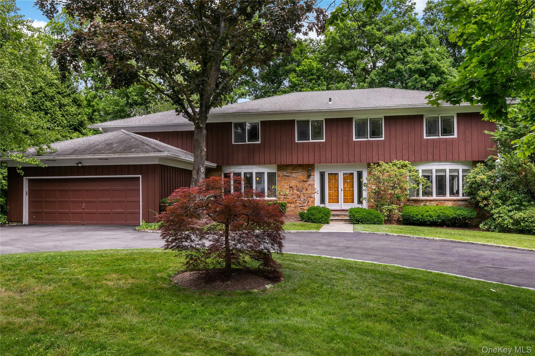 16 Meadow Road Scarsdale, NY 10583 - Photo 1 of 47 a front view of a house with a garden and yard