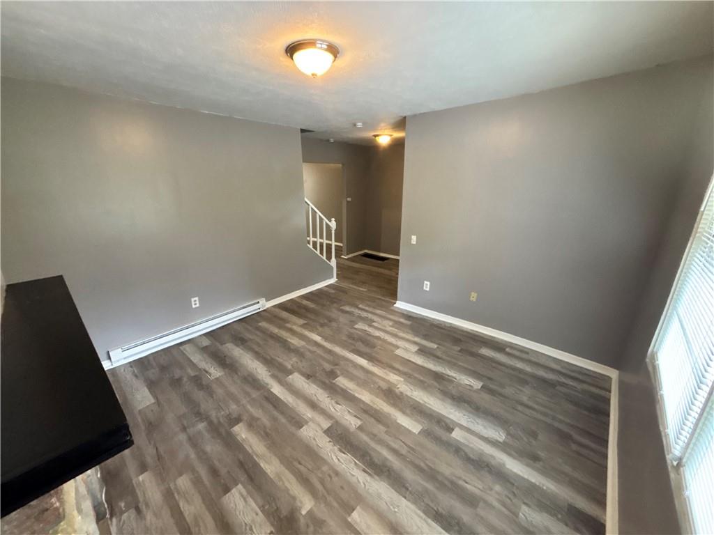 335 Cedarhurst Street Pittsburgh, PA 15210 - Photo 3 of 28 an empty room with wooden floor and windows