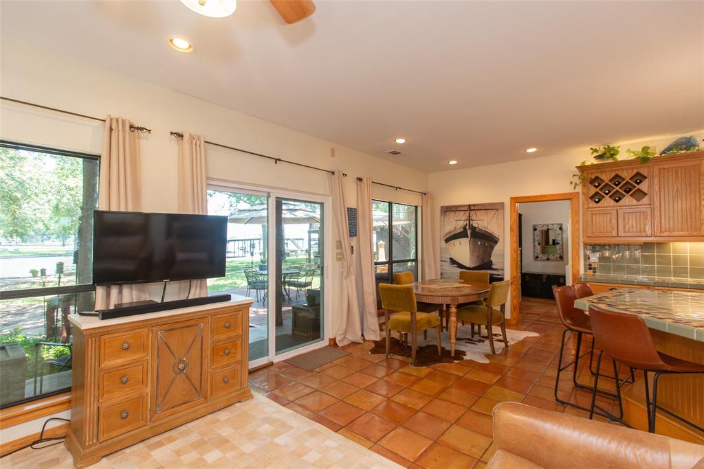 121 Xit Ranch Road Trinidad, TX 75163 - Photo 12 of 40 The interior features extensive tile flooring, large windows, and a sliding glass door providing access to covered back deck, large yard and the lake.