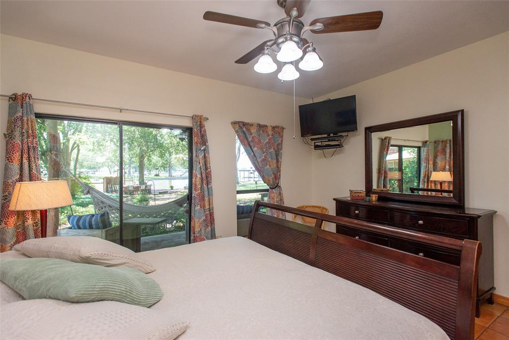 121 Xit Ranch Road Trinidad, TX 75163 - Photo 14 of 40 This bedroom offers direct access to the back yard, deck and lake, providing views of mature trees and the lake.