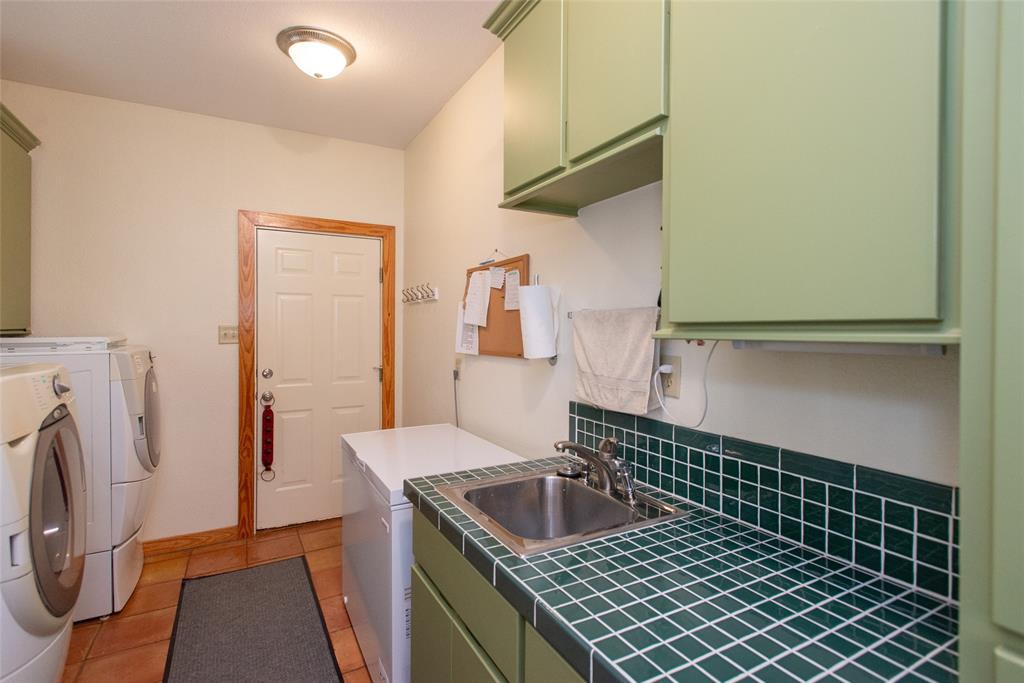 121 Xit Ranch Road Trinidad, TX 75163 - Photo 22 of 40 Utility area featuring a ceramic tiled floor, a sink with a tiled countertop and backsplash, and light green cabinetry