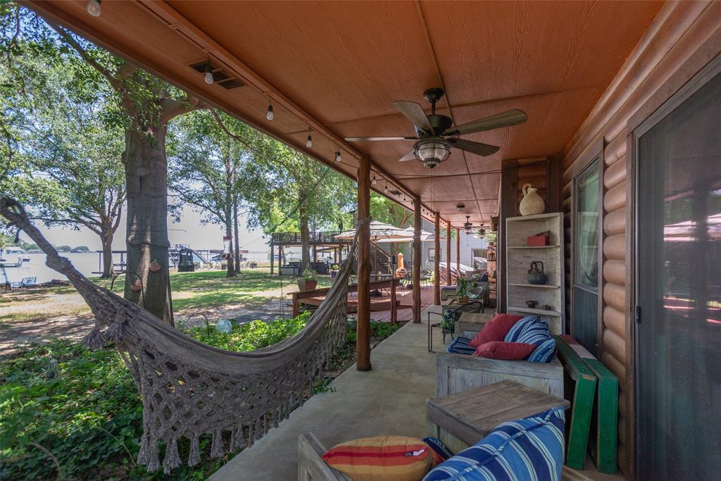 121 Xit Ranch Road Trinidad, TX 75163 - Photo 25 of 40 The covered porch features a ceiling fan, recessed lighting, and offers views of mature trees and Cedar Creek Lake
