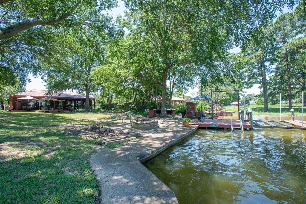 121 Xit Ranch Road Trinidad, TX 75163 - Photo 33 of 40 This property features a lakeside setting with a private wooden deck and boat dock, providing direct access to the water