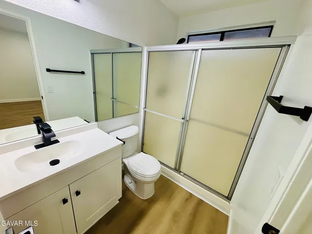 a bathroom with a sink mirror vanity and toilet