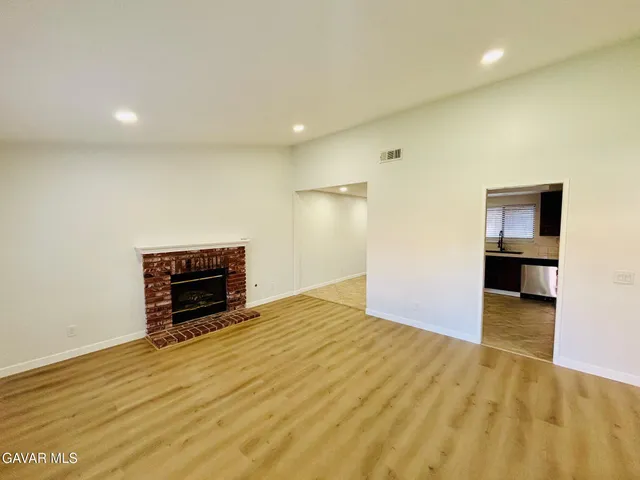 a view of empty room with a fireplace