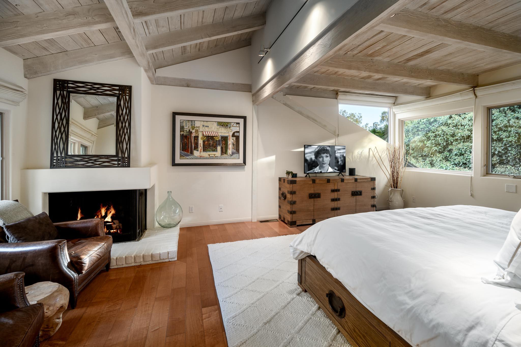 790 Ayala Lane Montecito, CA 93108 - Photo 11 of 24 a bedroom with a bed and a fireplace