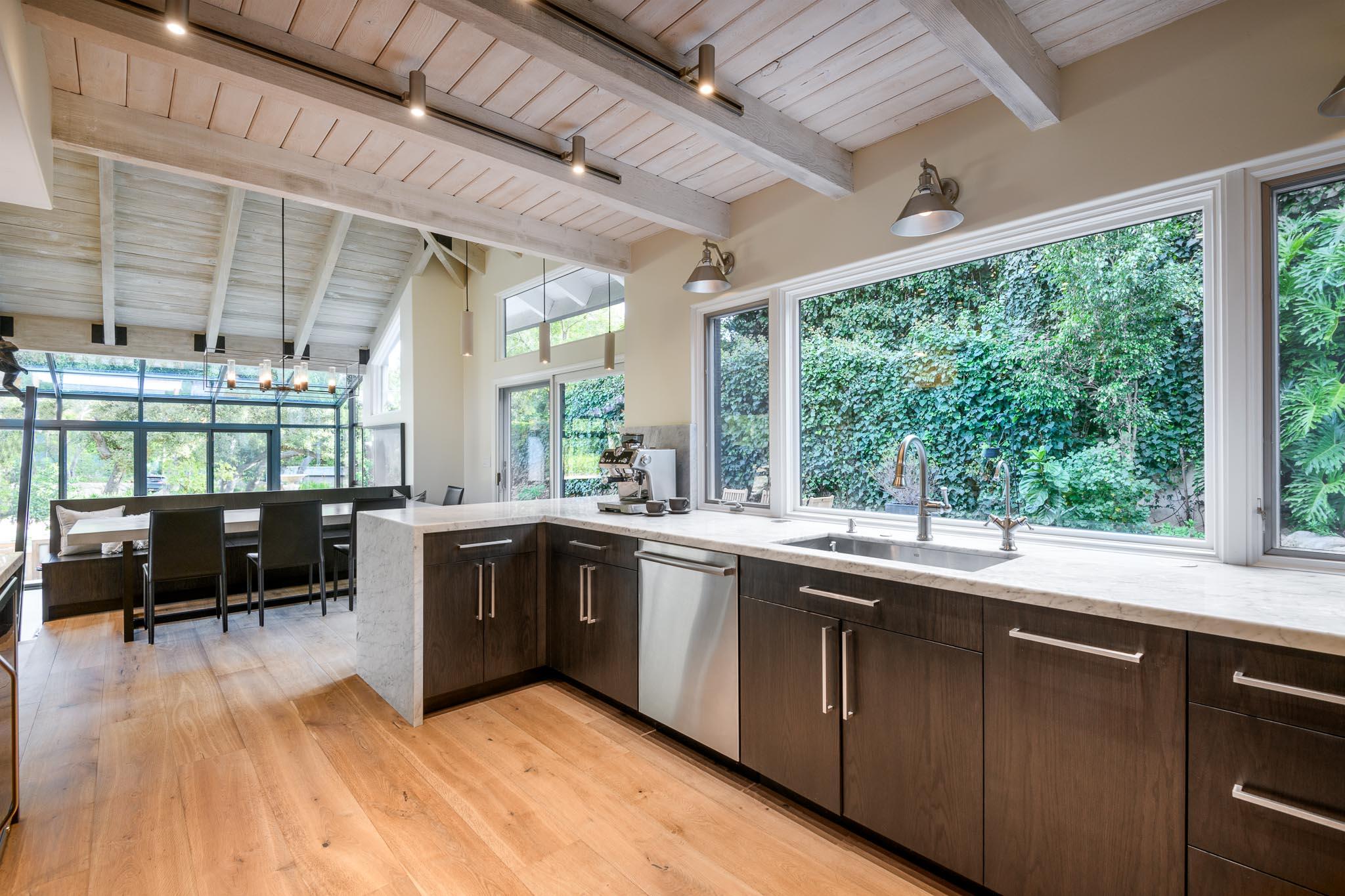 790 Ayala Lane Montecito, CA 93108 - Photo 7 of 24 a kitchen with lots of counter top space and wooden floor