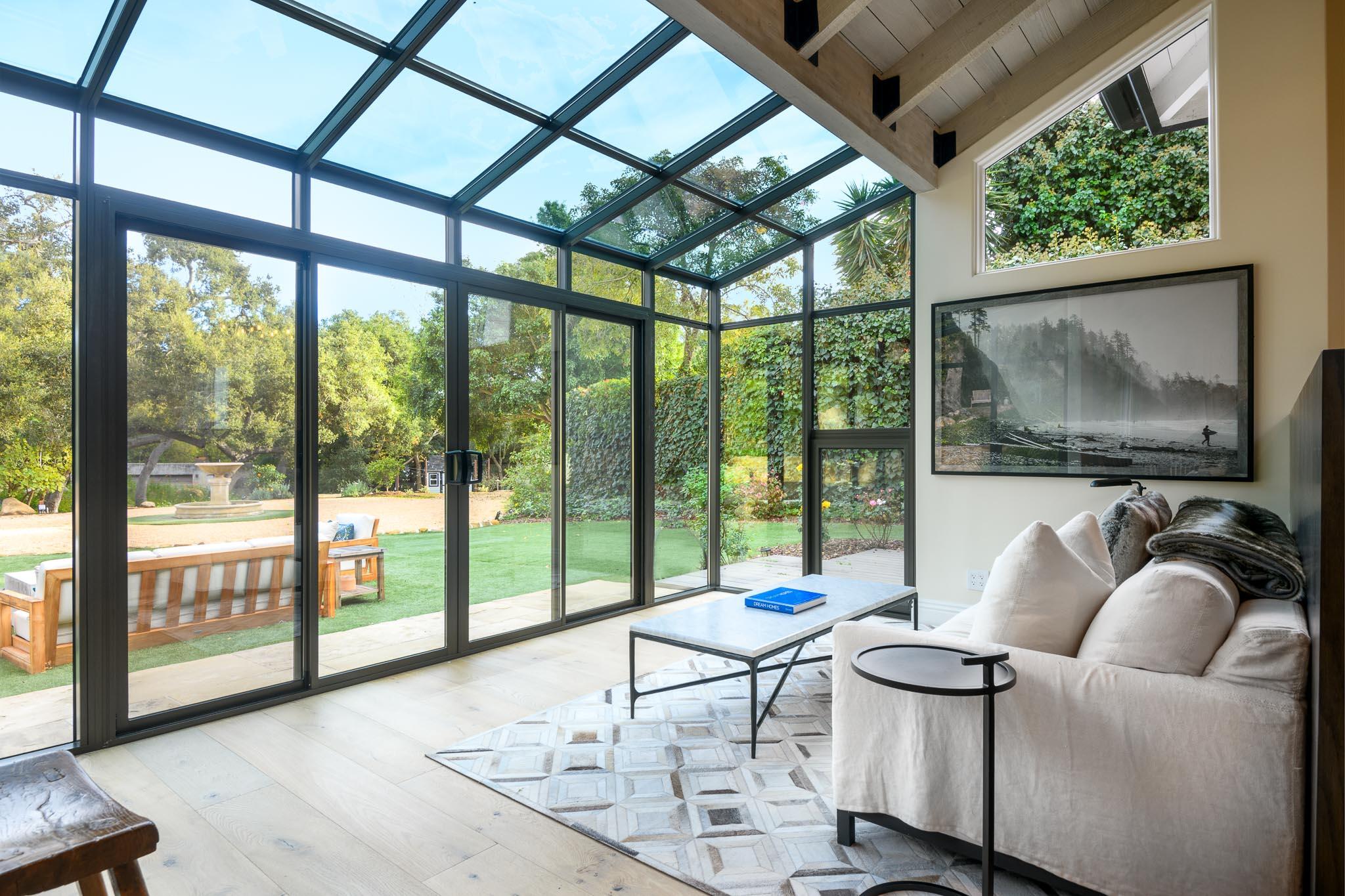 790 Ayala Lane Montecito, CA 93108 - Photo 9 of 24 a living room with furniture and a floor to ceiling window