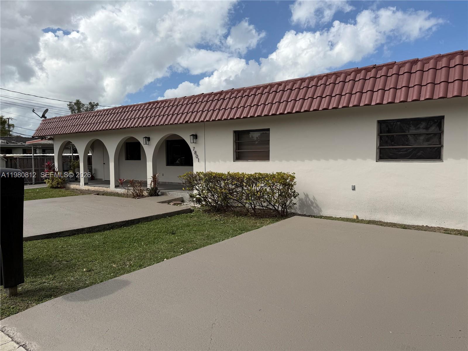 7801 Southwest 12th Street, Unit 7801 Miami, FL 33144 - Photo 2 of 12 a front view of a house with garden
