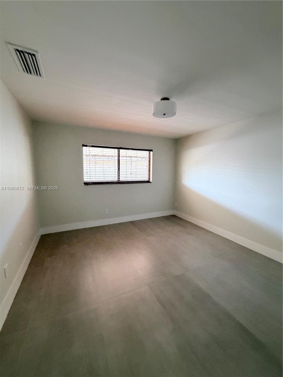 7801 Southwest 12th Street, Unit 7801 Miami, FL 33144 - Photo 7 of 12 an empty room with a window
