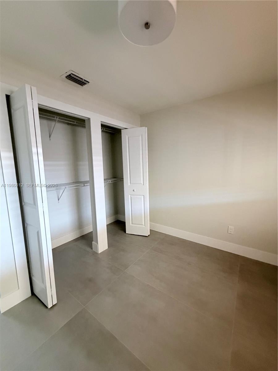 7801 Southwest 12th Street, Unit 7801 Miami, FL 33144 - Photo 8 of 12 an empty room with a door