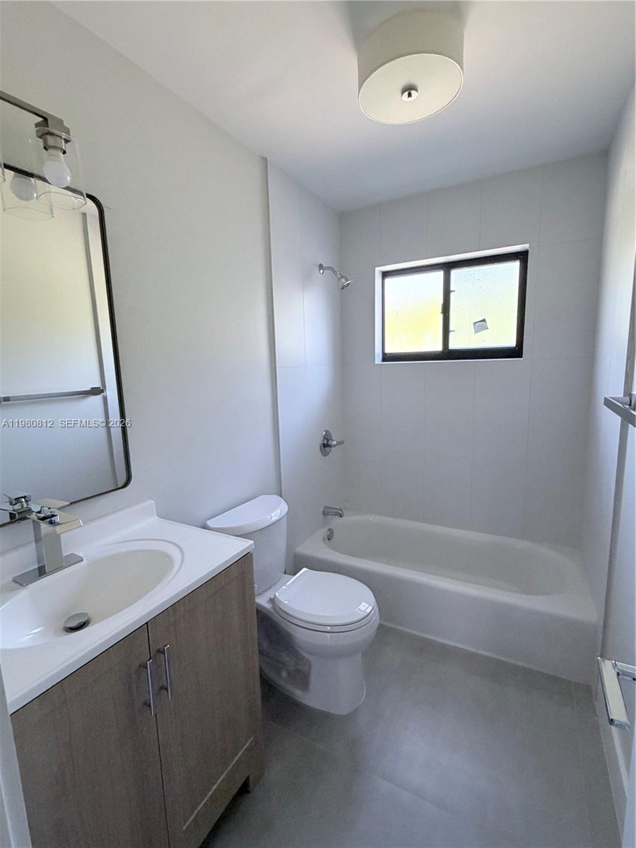 7801 Southwest 12th Street, Unit 7801 Miami, FL 33144 - Photo 10 of 12 a bathroom with a toilet a sink and bathtub