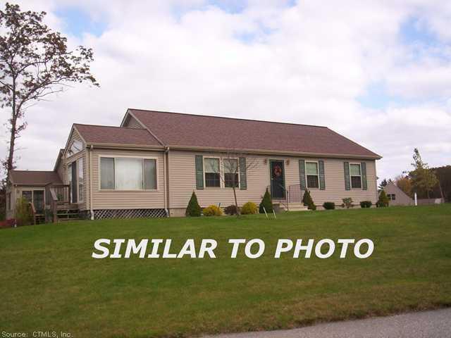 16 Oriole Drive, Unit 16 Killingly, CT 06239 - Photo 1 of 1 a front view of a house with a garden