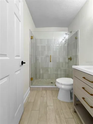 a bathroom with a toilet a sink and shower