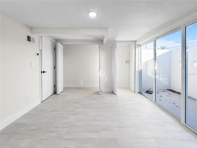 an empty room with wooden door