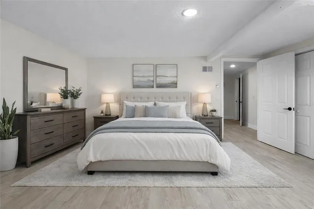 a bedroom with a bed and a dresser