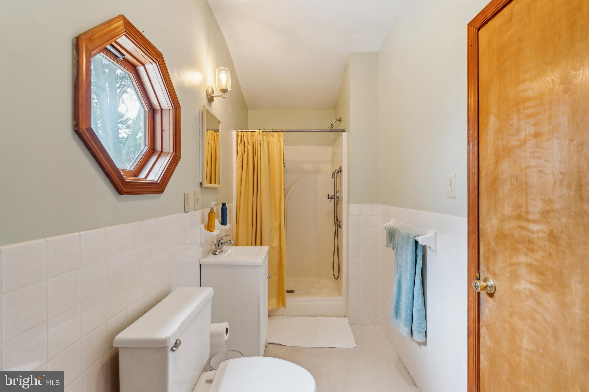 125 Township Line Road Jenkintown, PA 19046 - Photo 21 of 41 a bathroom with a toilet a sink and a mirror