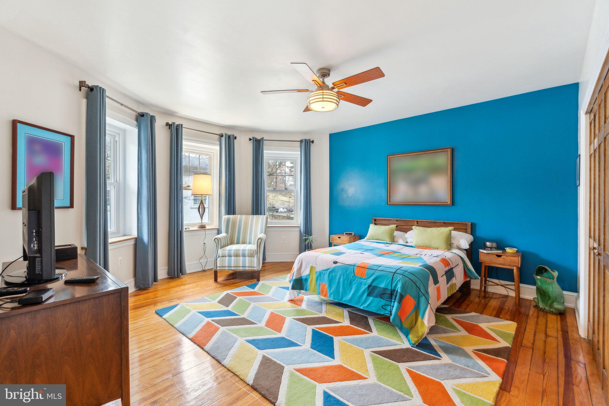 125 Township Line Road Jenkintown, PA 19046 - Photo 22 of 41 a bedroom with a bed and a chandelier