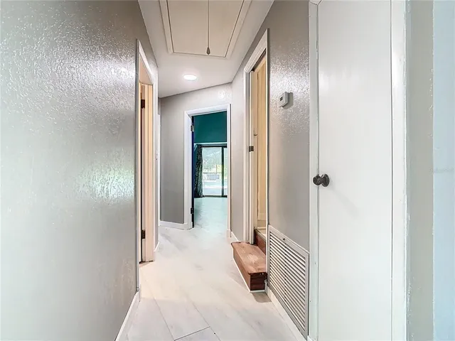 an empty room with windows and closet