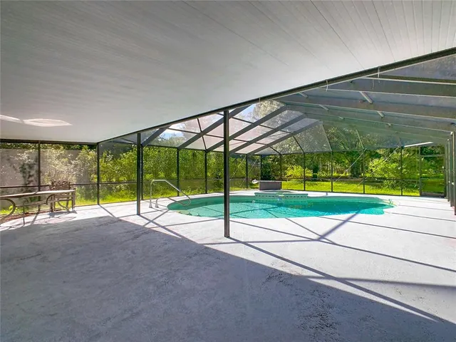 a view of a patio with a table chairs and a backyard