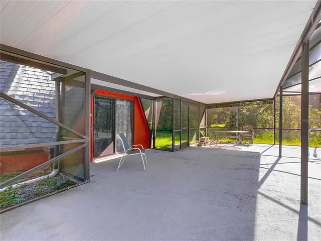 a view of a backyard with table and chairs under an umbrella