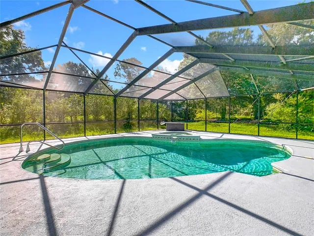 a house view with a swimming pool and garden