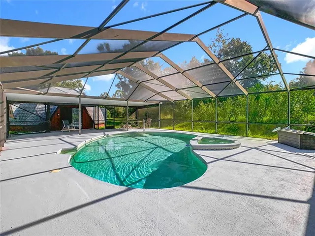 a view of a backyard with a garden and entertaining space