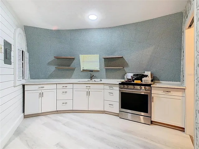 a view of kitchen with refrigerator and window