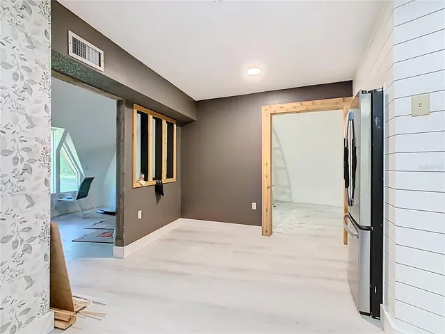 a kitchen with granite countertop a stove and refrigerator