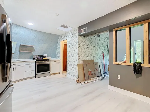 a view of an empty room with windows