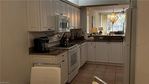 a kitchen with stainless steel appliances white cabinets and a sink