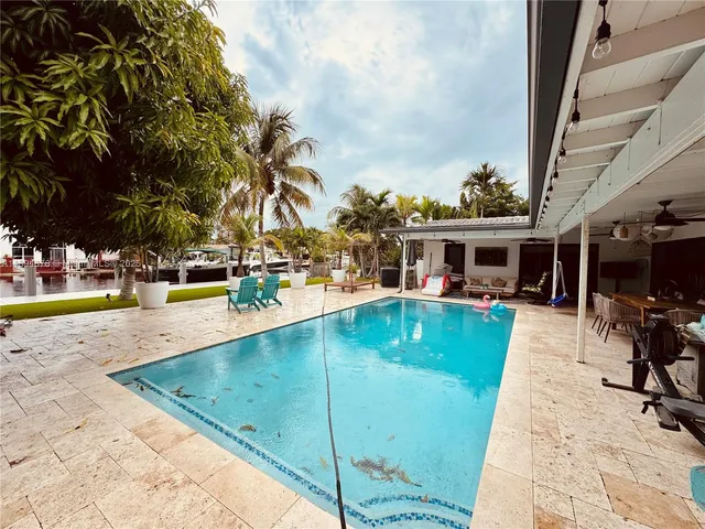 a view of a swimming pool with a patio
