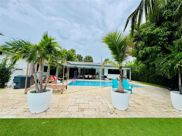 a view of a dining room with furniture wooden floor and a potted plant
