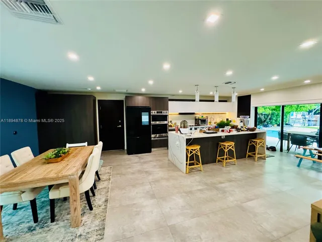 a view of a living room with a floor to ceiling window and wooden floor