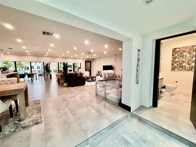 a living room with furniture bathtub and a flat screen tv