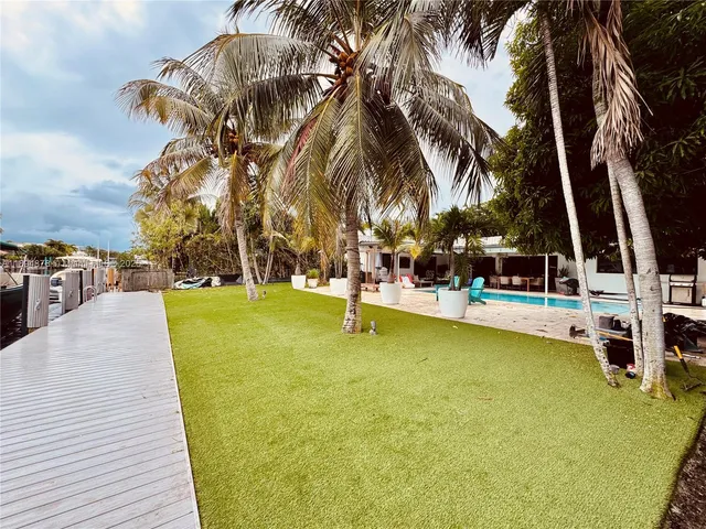 a swimming pool with outdoor seating and yard