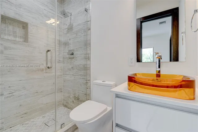 a bathroom with a toilet sink and shower