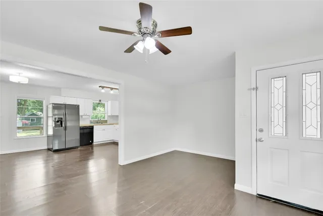 wooden floor in an empty room with a window