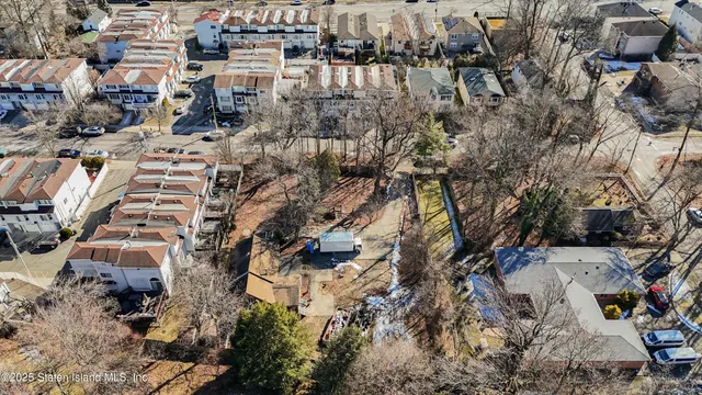 an aerial view of residential building and parking space