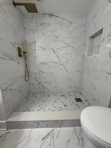 a bathroom with a toilet and shower