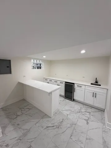 a large white kitchen with cabinets