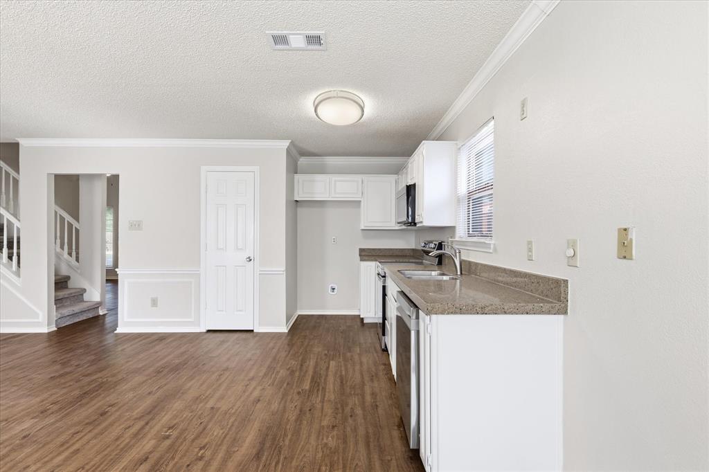 318 Lodge Road Coppell, TX 75019 - Photo 20 of 35 Crisp white cabinetry, stainless-steel appliances and generous counter space create a clean, functional kitchen ready for your personal touch.