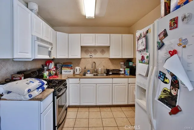 a kitchen with a refrigerator a stove top oven a sink and dishwasher