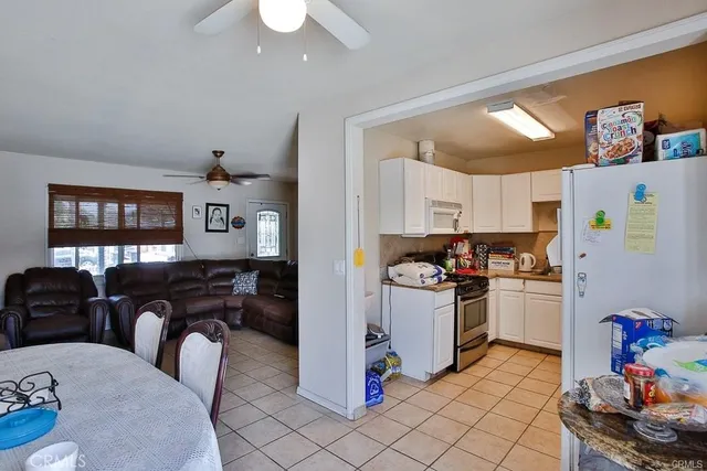 a kitchen with refrigerator and cabinets