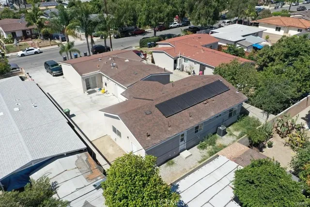 an aerial view of a house with a yard