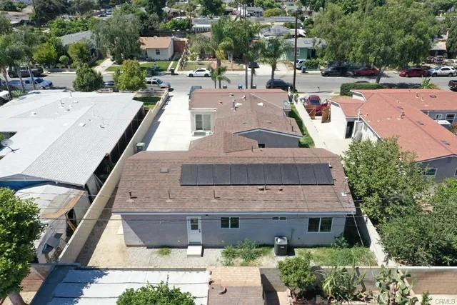 an aerial view of a house with a yard
