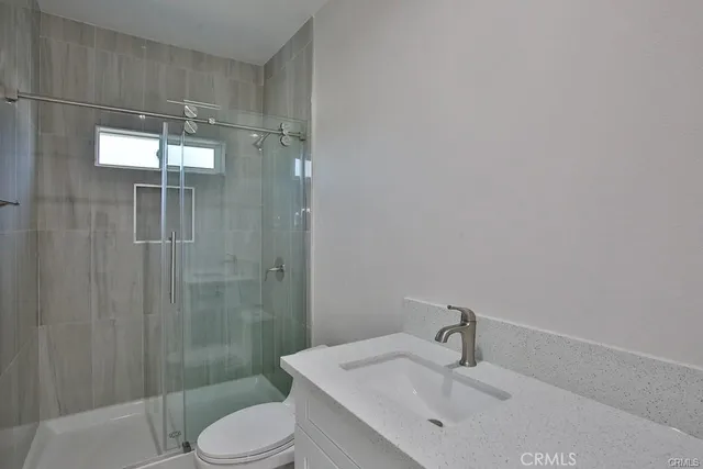 a bathroom with a sink vanity mirror and toilet