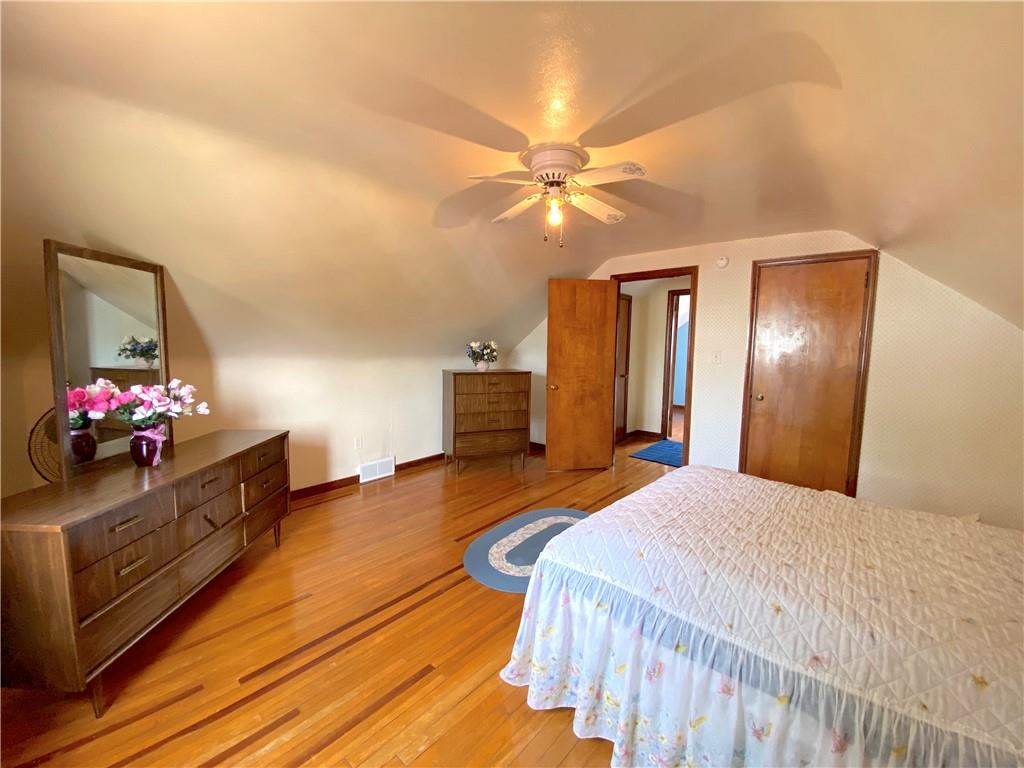 560 Center Hill Road Pittsburgh, PA 15239 - Photo 20 of 25 a bedroom with a bed and a chandelier